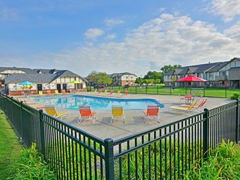 Outdoor pool and wrap around sundeck at Huntington Place Apartments in Essexville, MI